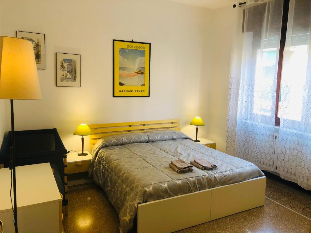 a bedroom with a bed with two books on it at Appartamenti Ancora Azzurra in Deiva Marina