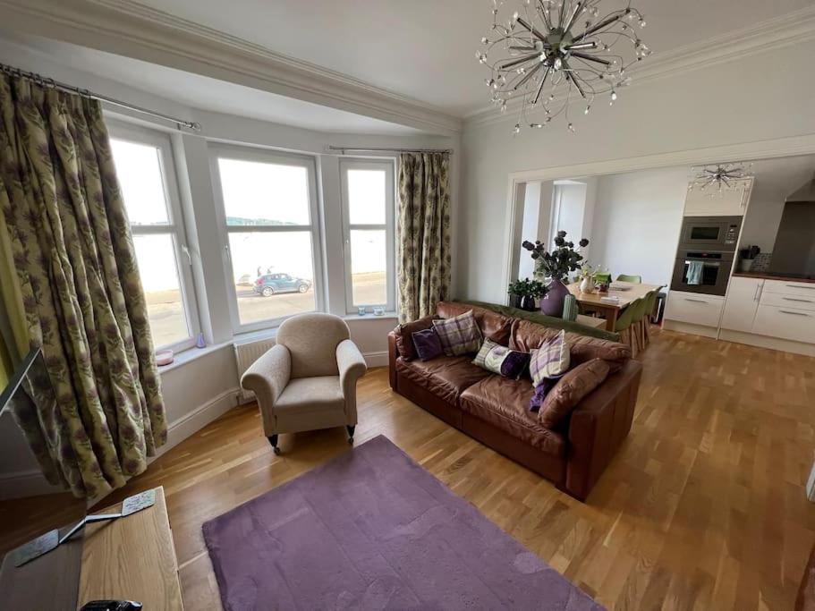 a living room with a couch and a chair at Fantastic 3 bedroom holiday home in Millport