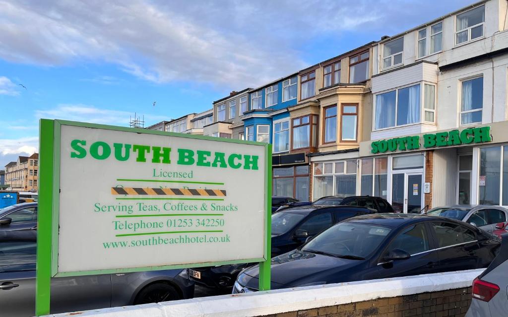 a sign in front of a parking lot with cars at South Beach Hotel in Blackpool