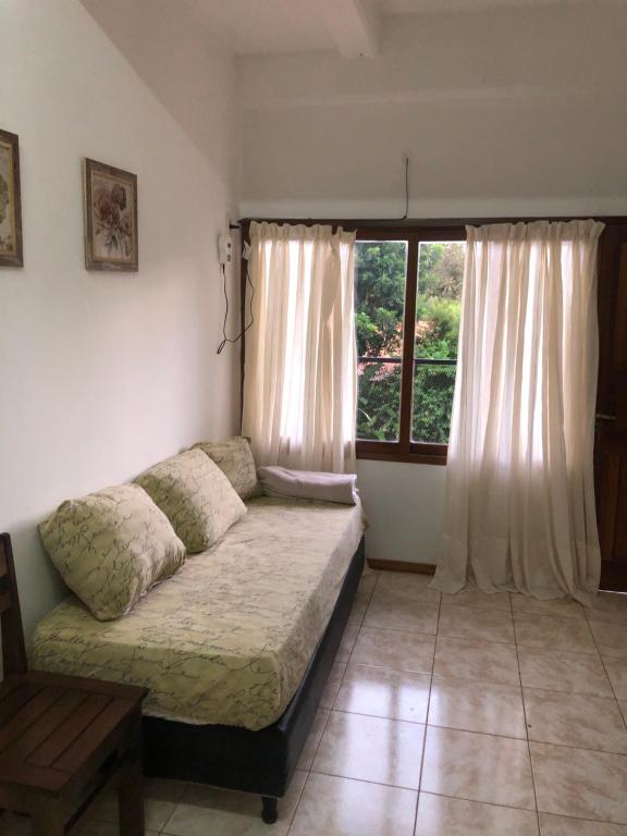 a living room with a couch and a window at Departamento de Magui en Montecarlo in Montecarlo