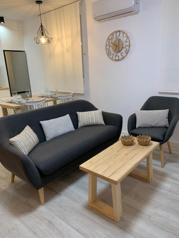 sala de estar con sofá y mesa de centro en APARTAMENTO MEDINA AZAHARA, en Córdoba