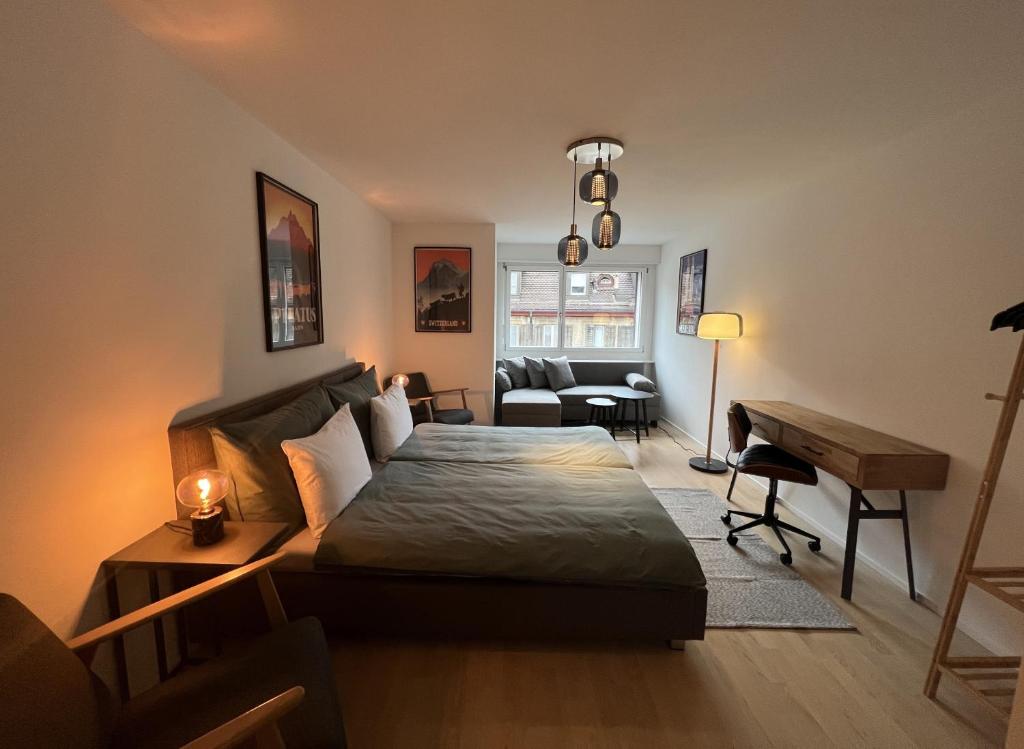 a bedroom with a bed and a living room at Swiss Art Apartment City Center in Zurich