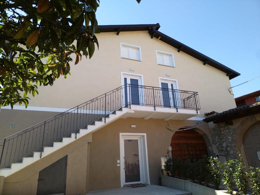 a house with a staircase on the side of it at Borgo alla Pieve Apartments by Garda Facilities in Manerba del Garda