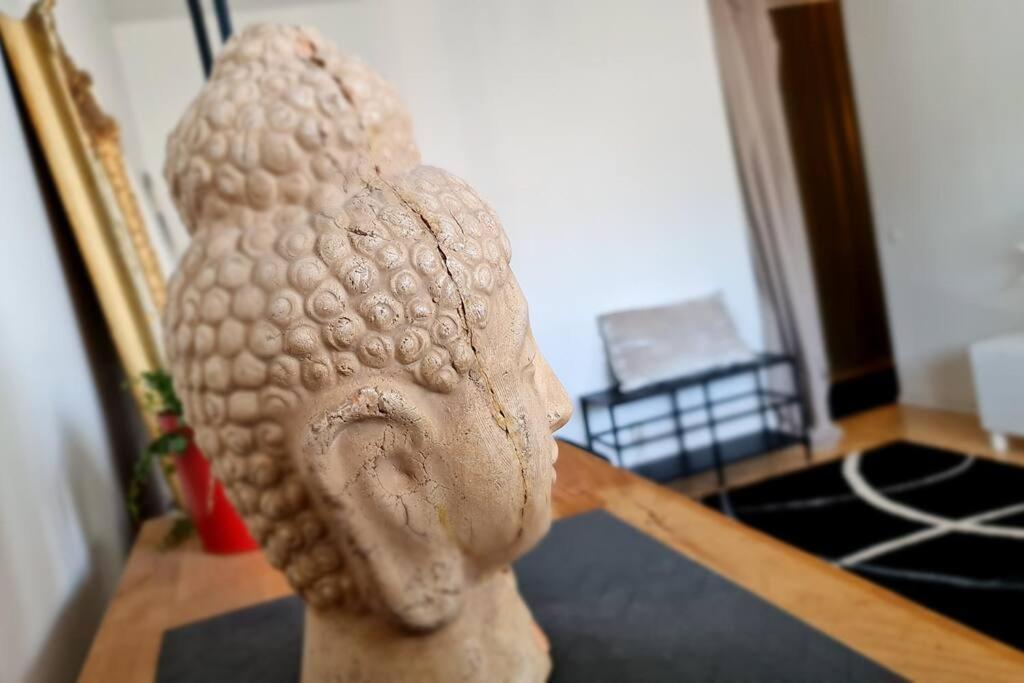 a statue of a head sitting on a table at Scandinavian 2-rooms apartment City Center in Helsinki