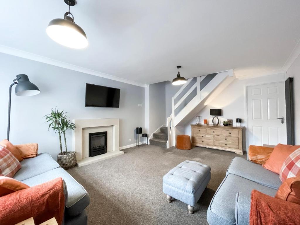 a living room with a couch and a fireplace at Well Situated, Cosy 2 Bed House in West Kirby