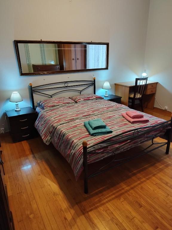 a bedroom with a large bed with a large mirror at Комната pilika 4room with shared bath in Athens