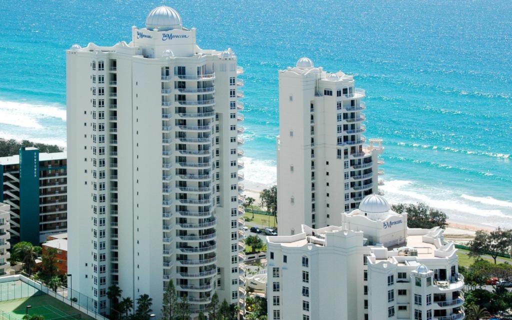 two tall white buildings next to the ocean at The Moroccan - QStay in Gold Coast