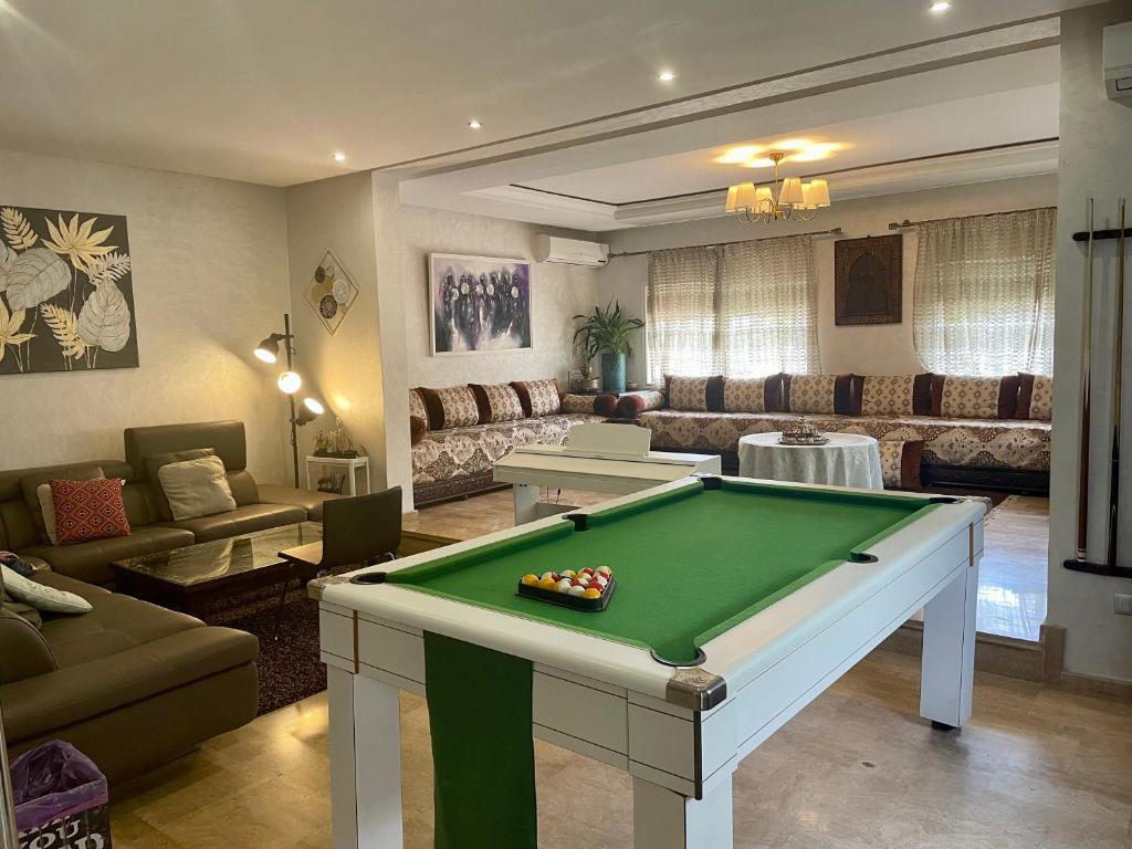 a living room with a pool table in it at Au Cœur Des Plages de Rabat in Oulad Kerroum
