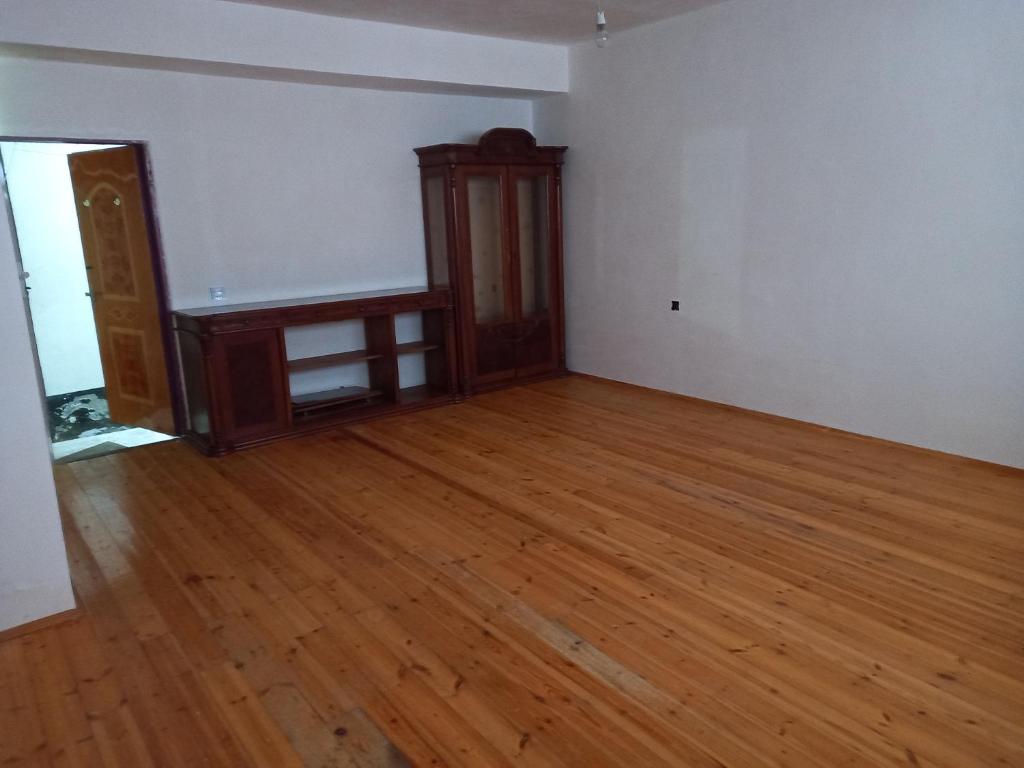 an empty living room with a wooden floor at Hostel 20 yanvar in Baku