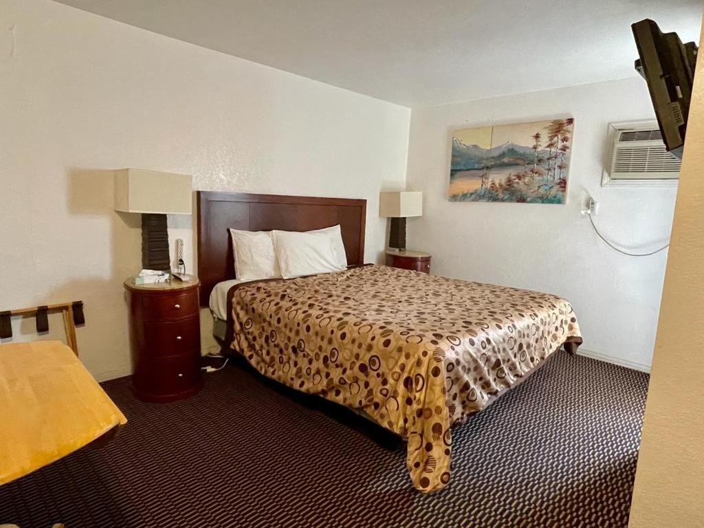 a hotel room with a bed with a leopard print spread at Desert Inn in Mojave