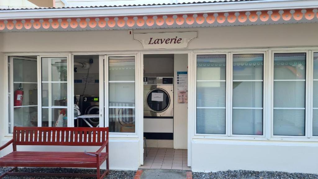 a red bench sitting outside of a store front at Pierre et Vacances Vue Mer in Sainte-Luce