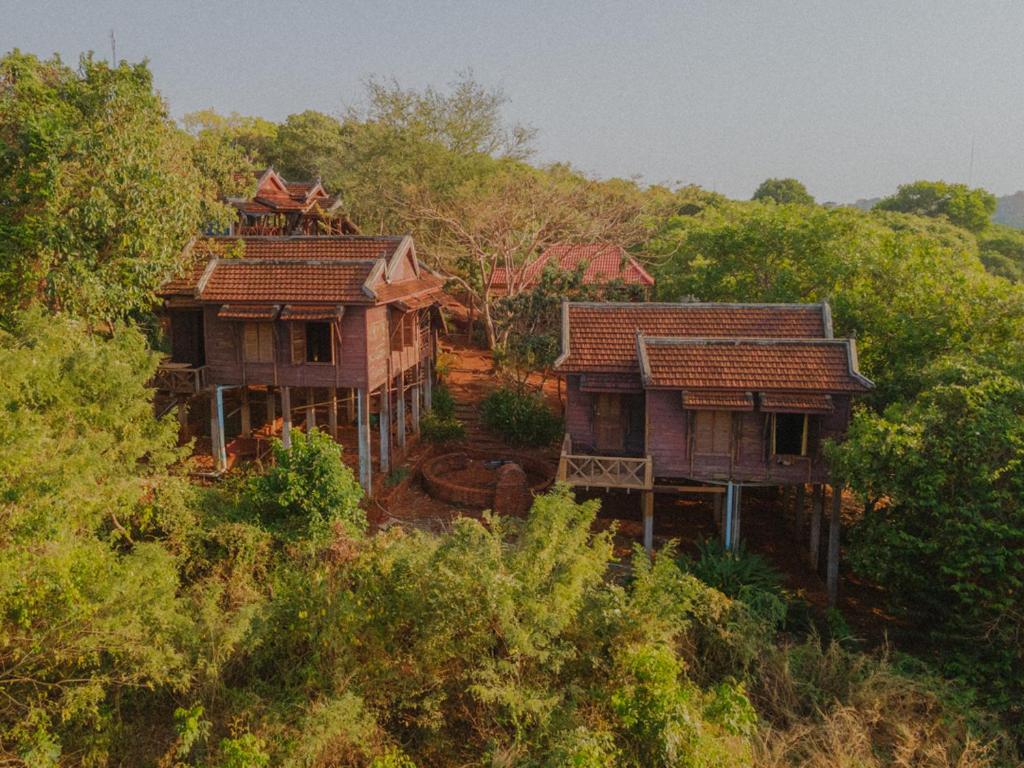 dwa domy siedzące na szczycie wzgórza z drzewami w obiekcie Quiet Garden View Lodge&Trekking w mieście Banlung