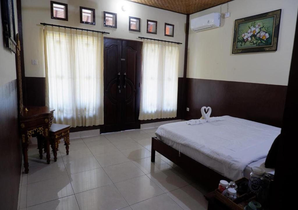 Postel nebo postele na pokoji v ubytování Danasari Homestay