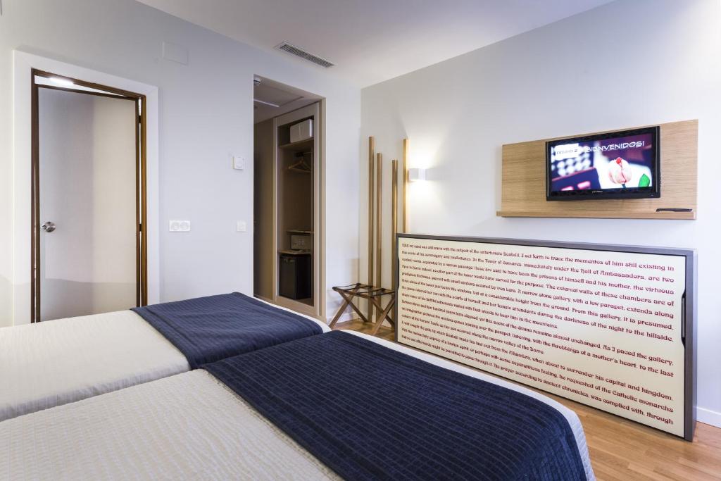 A bed or beds in a room at Hotel Comfort Dauro 2