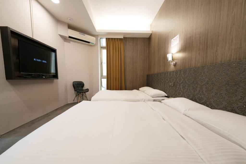 Postel nebo postele na pokoji v ubytování Meworld Hotel - Ximen