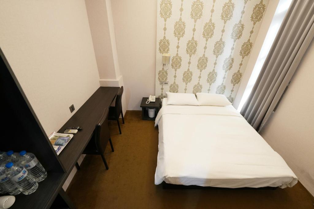 Postel nebo postele na pokoji v ubytování Meworld Hotel - Ximen