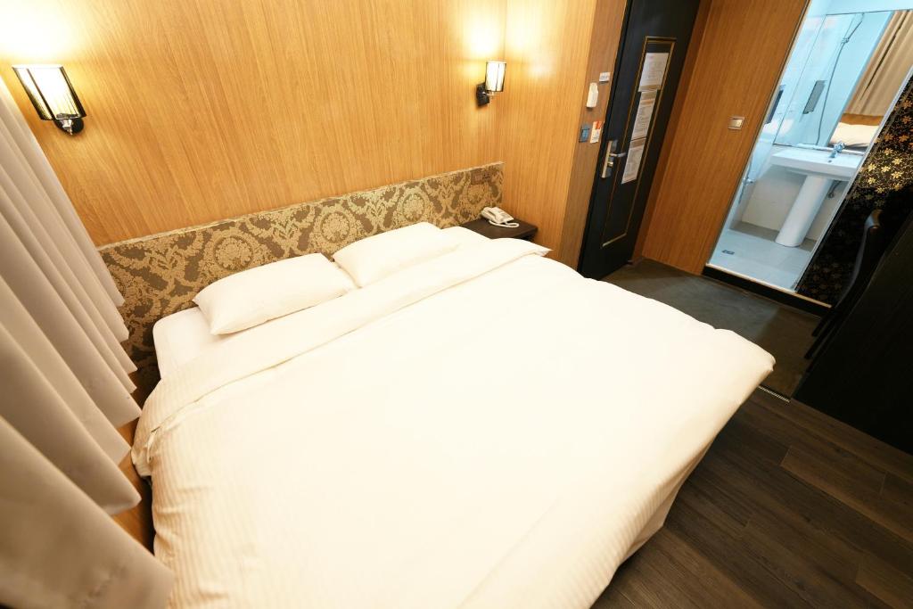 Postel nebo postele na pokoji v ubytování Meworld Hotel - Ximen