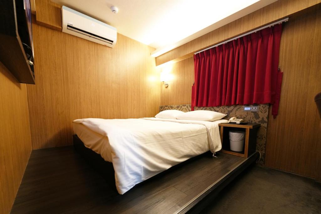Postel nebo postele na pokoji v ubytování Meworld Hotel - Ximen