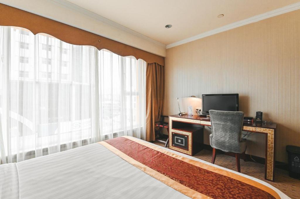 Postel nebo postele na pokoji v ubytování Royal Plaza Hotel