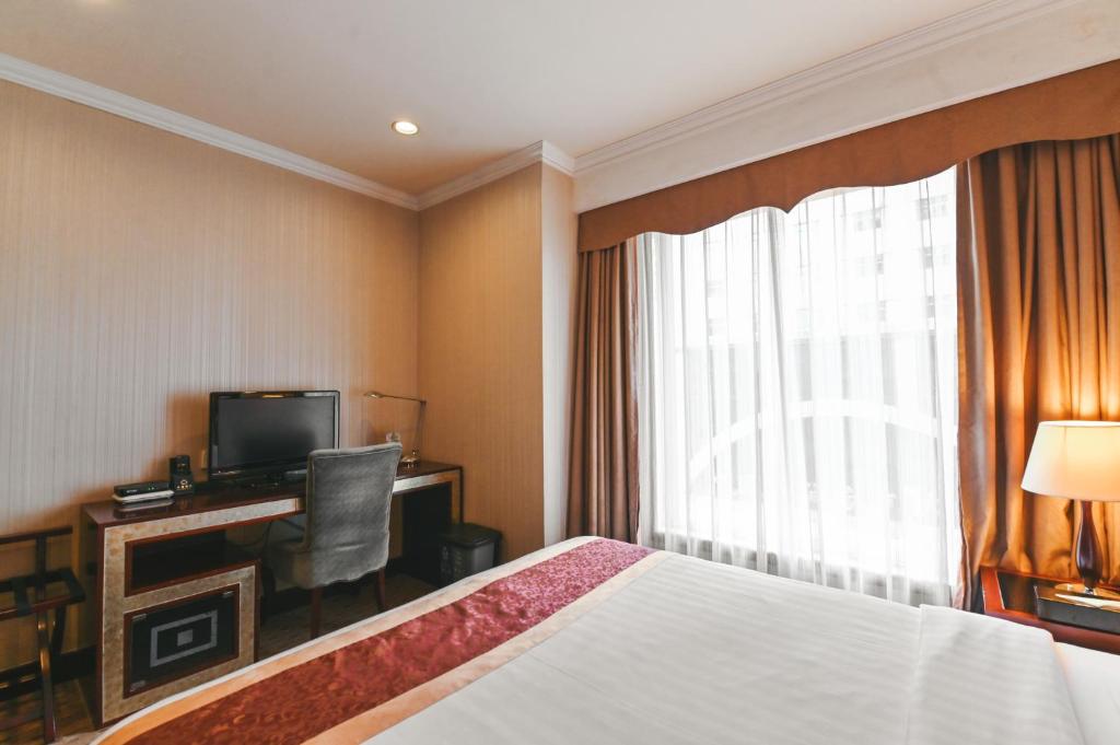 Postel nebo postele na pokoji v ubytování Royal Plaza Hotel