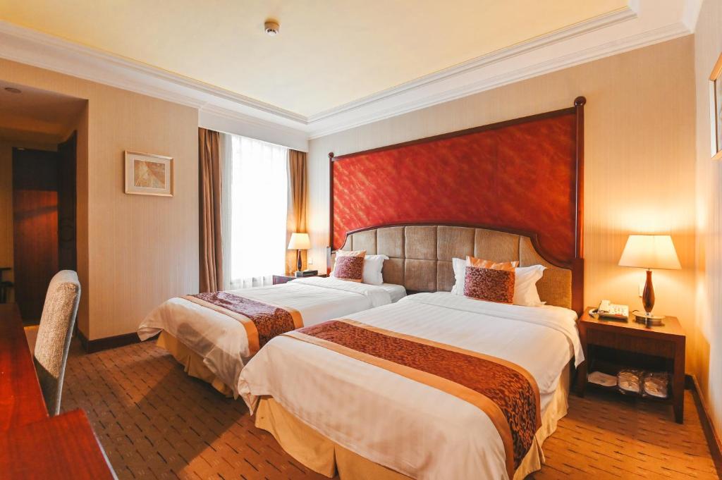 Postel nebo postele na pokoji v ubytování Royal Plaza Hotel