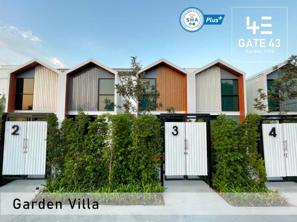a house with white doors and a fence at Gate43 Garden Villa in Bangkok