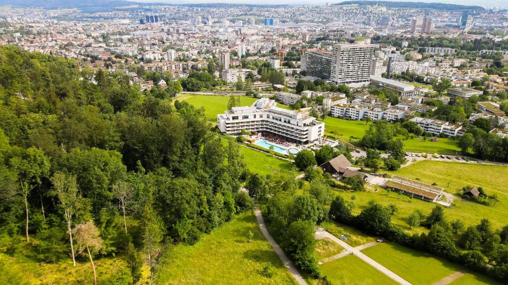 an aerial view of a city with buildings and trees at FIVE Zurich - Luxury City Resort in Zürich