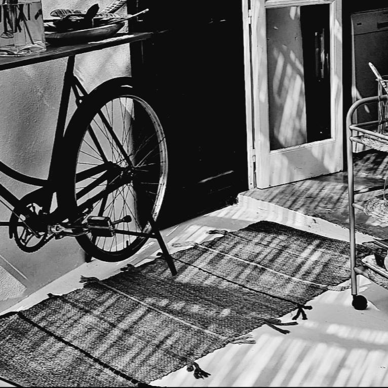 a bike parked in a room with a door at Casa BOHO in Alaminos