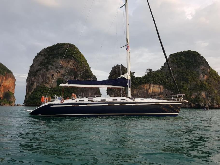 a sailboat in the water with at 53ft Sailing Yacht PHUKET Family Sailing adventure in Bang Tao Beach