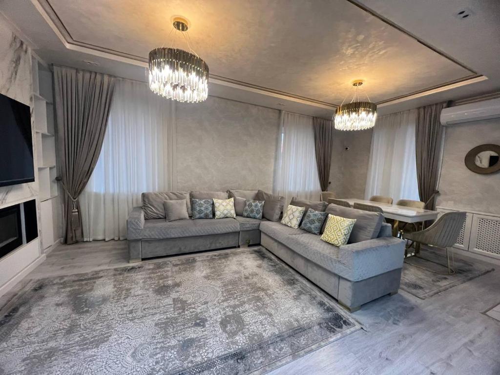 uma sala de estar com um sofá e uma mesa em lux apartment in tashkent city em Tashkent