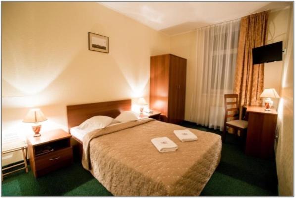 Postel nebo postele na pokoji v ubytování Dinaburg SPA Hotel