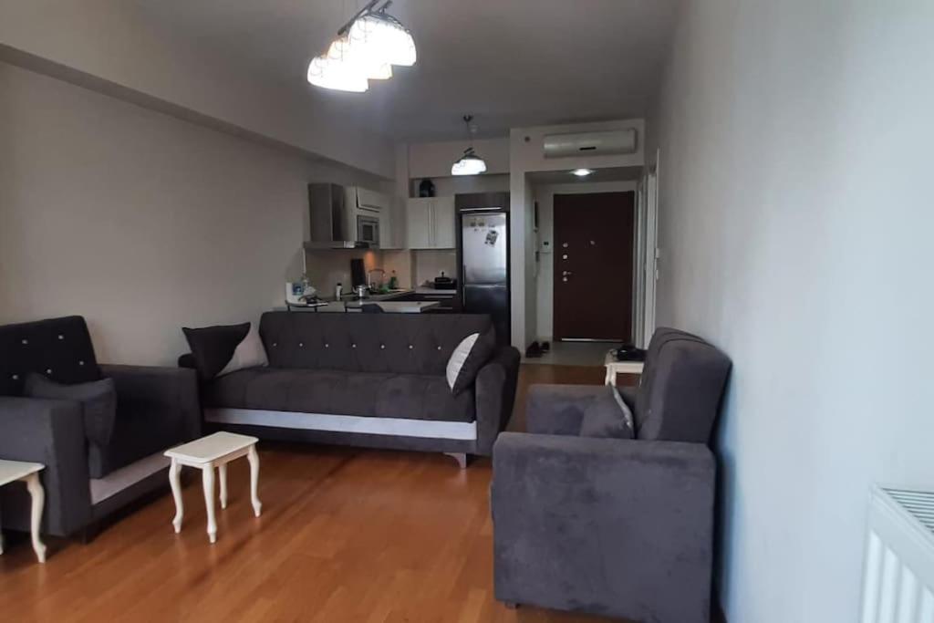 a living room with a couch and chairs and a kitchen at Amazing view Large 1 bed 1 bath lovely apartment in Esenyurt
