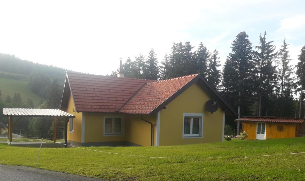 a small yellow house with a red roof at Ferienhaus Kitting in Lembach