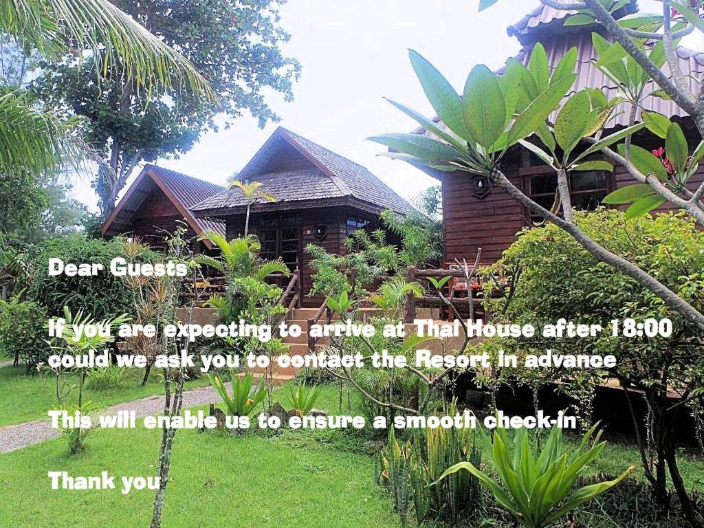 a sign in front of a house with a quote at Thai House Beach Resort in Ko Lanta