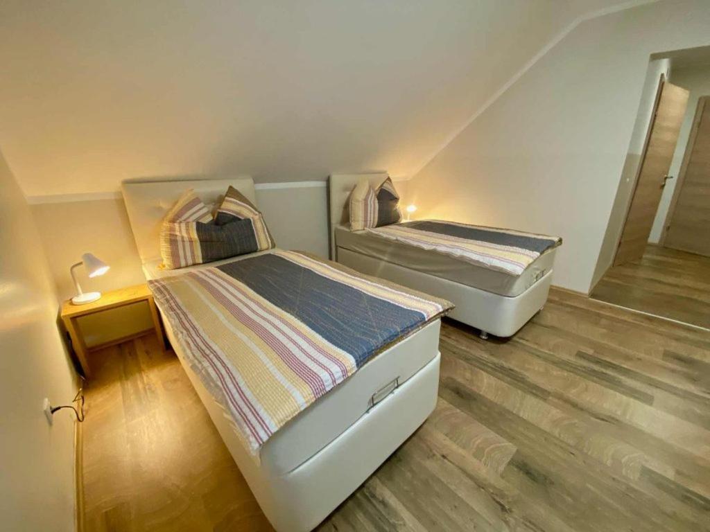 two beds in a small room with at Pension Austria in Mitterdorf im Mürztal
