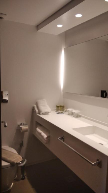 a bathroom with a sink and a mirror at Spetses Hotel in Spetses