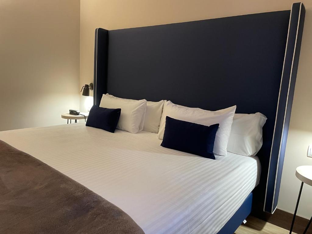 Postel nebo postele na pokoji v ubytování Hotel Maria Cristina