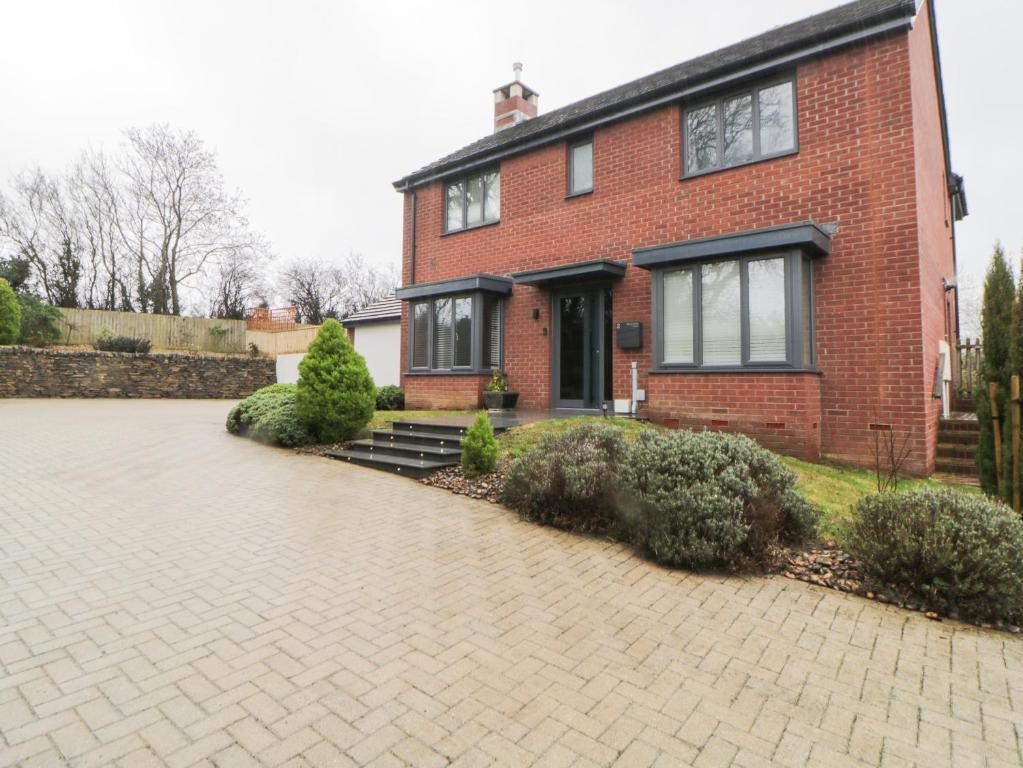 a brick house with a brick driveway in front of it at 2 White Rock Court in Paignton