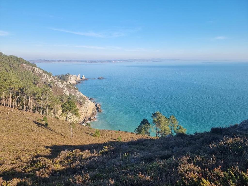 a view of the ocean from a hill at Maison typique bretonne a 5 min de la plage a pied in Crozon