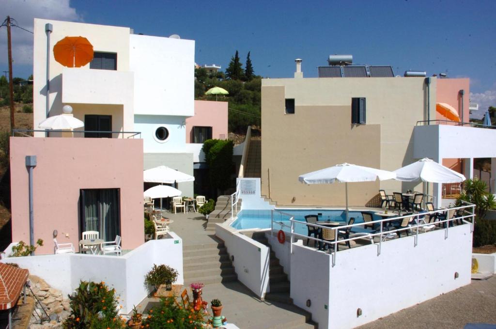 a view of a house with a swimming pool at Blue Sky Hotel Apartments in Tolo