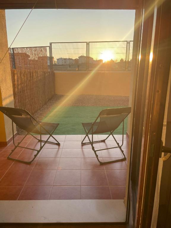 two chairs on a balcony with a view of a field at Casa Valero in Rubielos de Mora