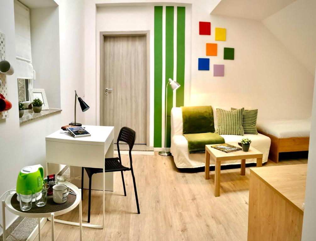 a living room with a couch and a table at Rainbow House Rooms in Maribor