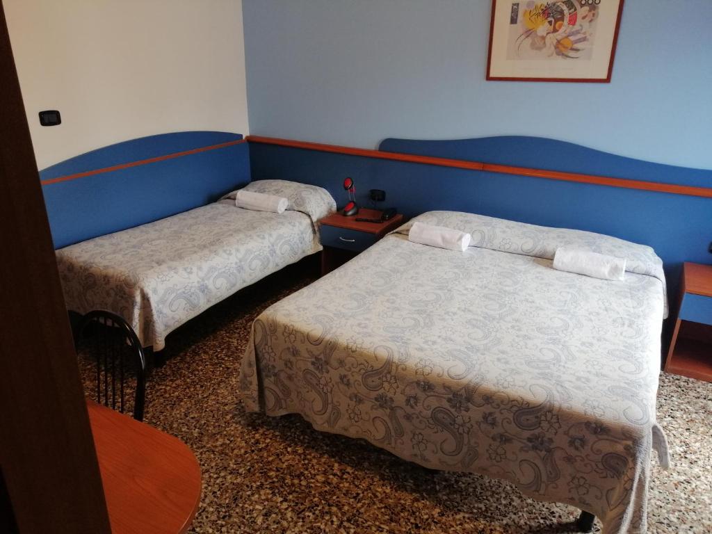 Postel nebo postele na pokoji v ubytování Hotel Trifoglio