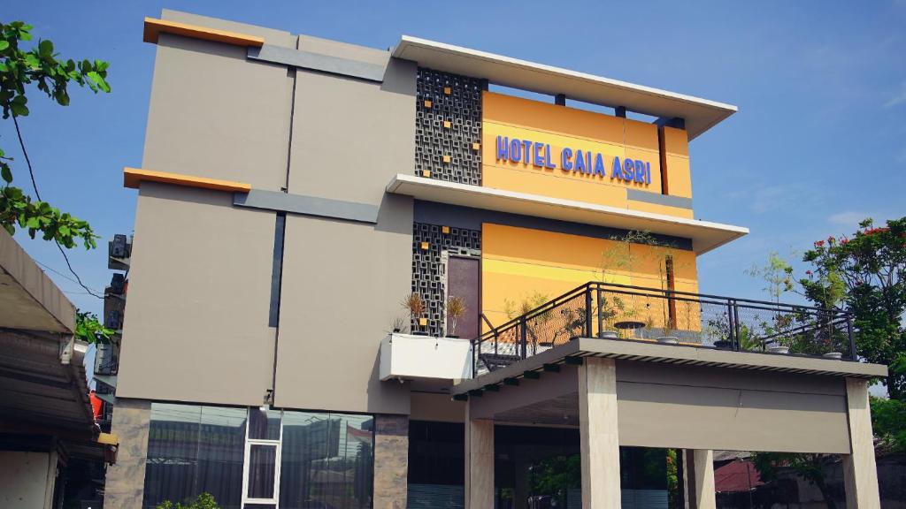 a building with a sign on the side of it at Gaia Asri Hotel in Pamanukan-hilir