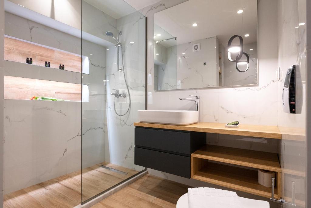 a bathroom with a sink and a shower at Traveleclectic Apartments in Corfu Town