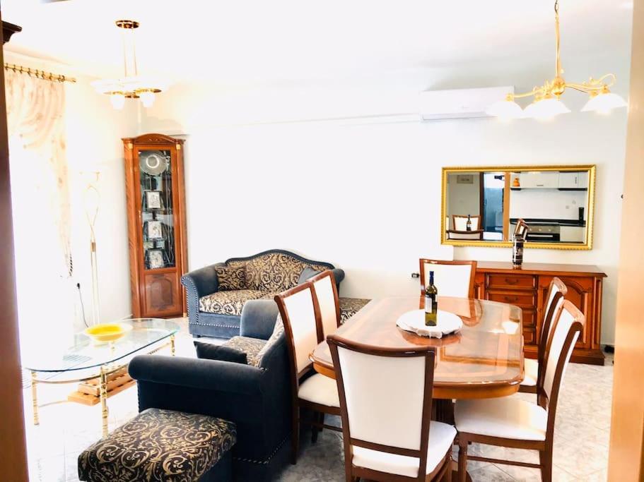 a living room with a dining room table and chairs at New elegant apartment in Kallithea Xalkidiki in Kallithea Halkidikis