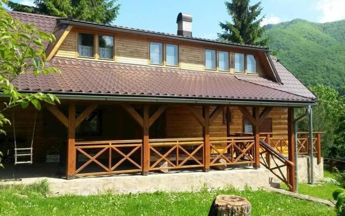 a large wooden house with a large deck at Chata Dreváčik in Svit