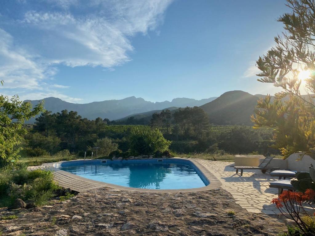 a swimming pool with mountains in the background at Wonderful comfortable finca in the Burga valley in Rasquera