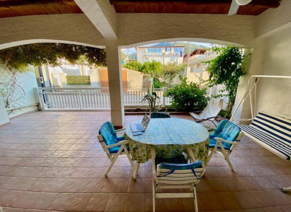 a patio with a table and chairs on a patio at CASA CELSA in Mongiove