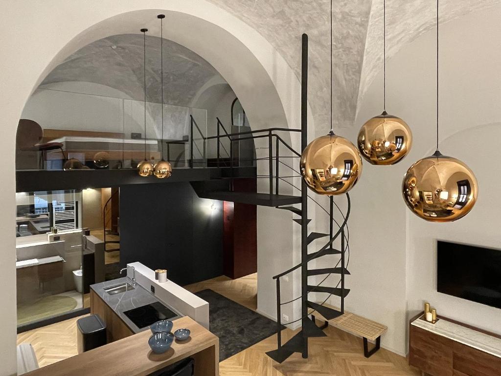 a loft apartment with a staircase and a living room at Le Dimore del Toscano in Catania